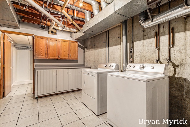 4675 44th St, Holland, MI 49423 - laundry area with cabinet space, washing machine and clothes dryer, and light tile patterned flooring
