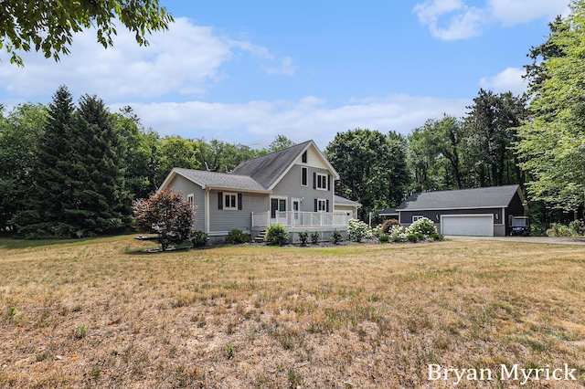 4675 44th St, Holland, MI 49423 - view of front of house featuring a front lawn, an outbuilding, and a wooden deck