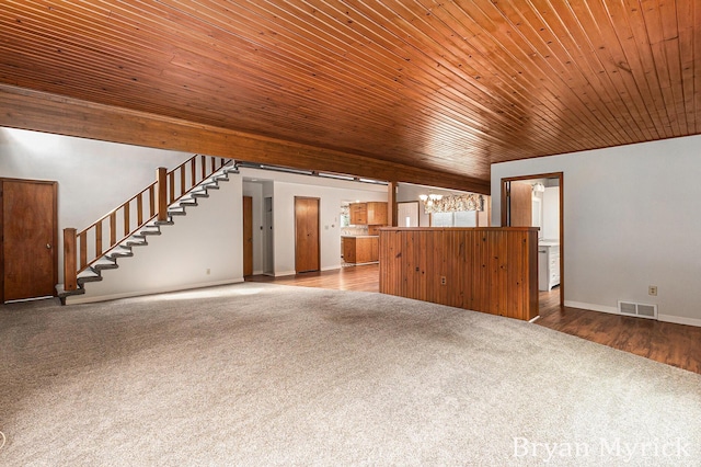 4675 44th St, Holland, MI 49423 - unfurnished living room with carpet floors, wood ceiling, and stairway