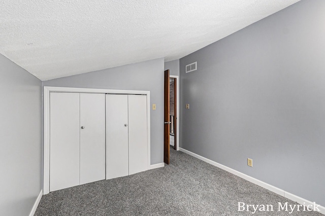 4675 44th St, Holland, MI 49423 - unfurnished bedroom with carpet floors, vaulted ceiling, a textured ceiling, and a closet