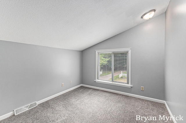 4675 44th St, Holland, MI 49423 - carpeted spare room with lofted ceiling and a textured ceiling