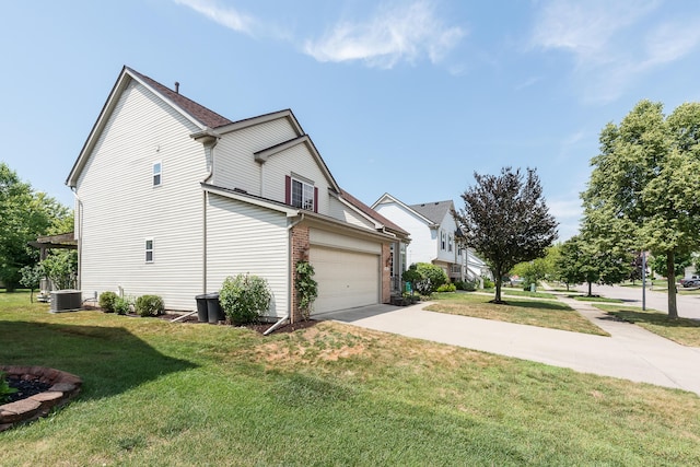6602 Robindale Dr, Ypsilanti, MI 48197 - view of home's exterior featuring a garage, concrete driveway, a yard, and brick siding