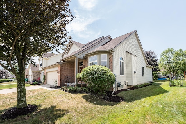 6602 Robindale Dr, Ypsilanti, MI 48197 - view of front facade with concrete driveway, an attached garage, and brick siding