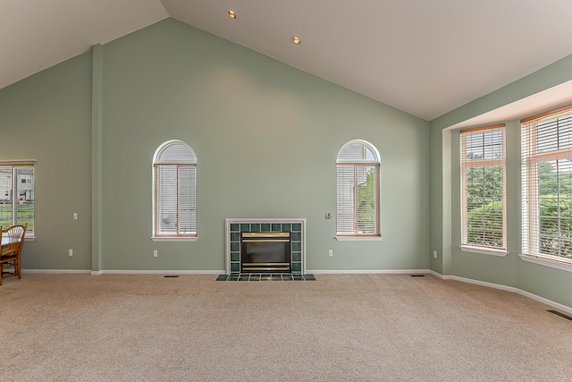 6602 Robindale Dr, Ypsilanti, MI 48197 - unfurnished living room featuring high vaulted ceiling, carpet, and a tile fireplace