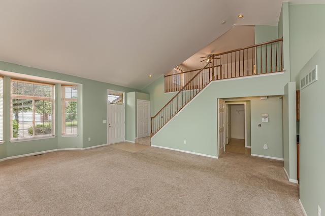 6602 Robindale Dr, Ypsilanti, MI 48197 - unfurnished living room featuring high vaulted ceiling, carpet, stairs, a ceiling fan, and recessed lighting