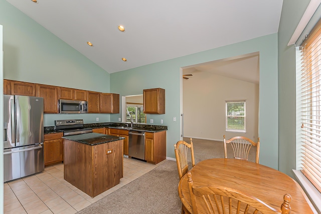 6602 Robindale Dr, Ypsilanti, MI 48197 - kitchen featuring appliances with stainless steel finishes, high vaulted ceiling, a kitchen island, healthy amount of natural light, and light tile patterned floors