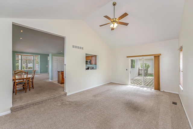 6602 Robindale Dr, Ypsilanti, MI 48197 - unfurnished living room featuring high vaulted ceiling, a ceiling fan, healthy amount of natural light, and light colored carpet