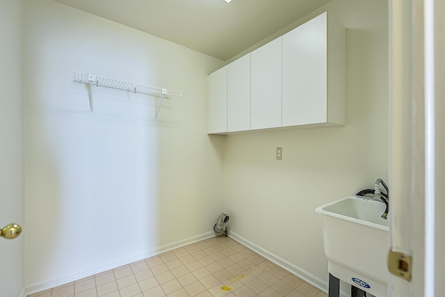 6602 Robindale Dr, Ypsilanti, MI 48197 - laundry room featuring cabinet space and light tile patterned floors