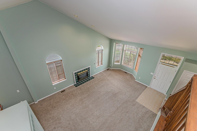 6602 Robindale Dr, Ypsilanti, MI 48197 - unfurnished living room featuring carpet floors, a fireplace with flush hearth, and vaulted ceiling
