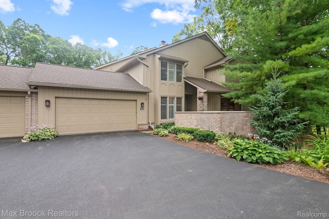1109 Ivyglen Cir, Bloomfield Hills, MI 48304 - view of front of property with brick siding, asphalt driveway, a garage, a chimney, and a shingled roof