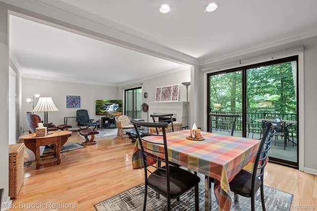 1109 Ivyglen Cir, Bloomfield Hills, MI 48304 - dining room featuring crown molding, a fireplace, and light wood-style floors