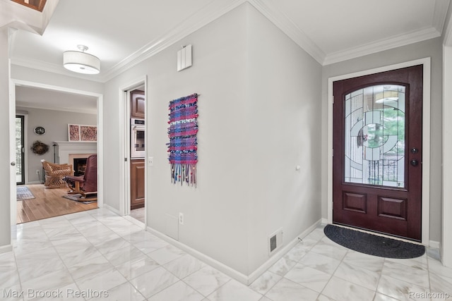 1109 Ivyglen Cir, Bloomfield Hills, MI 48304 - foyer entrance featuring plenty of natural light, ornamental molding, light marble finish flooring, and a fireplace
