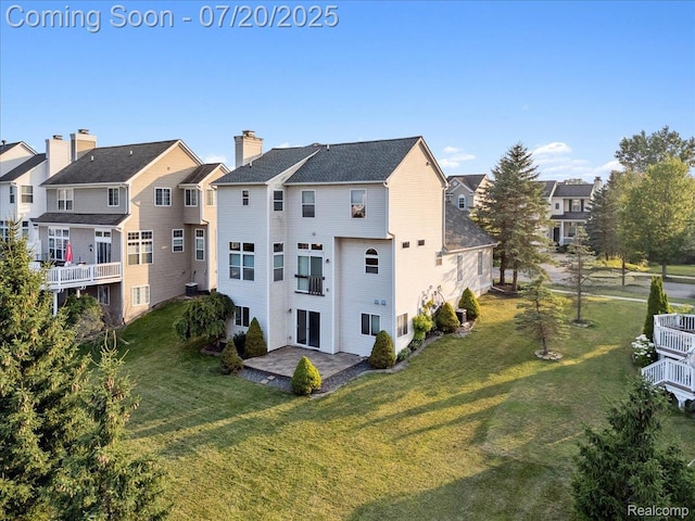 1145 York Ave, Howell, MI 48843 - rear view of house featuring a yard, a chimney, a patio area, and a residential view