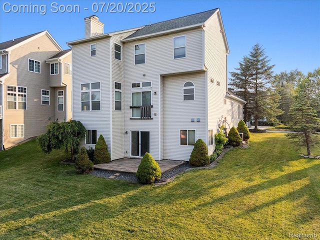 1145 York Ave, Howell, MI 48843 - back of house with a patio, a yard, and a chimney