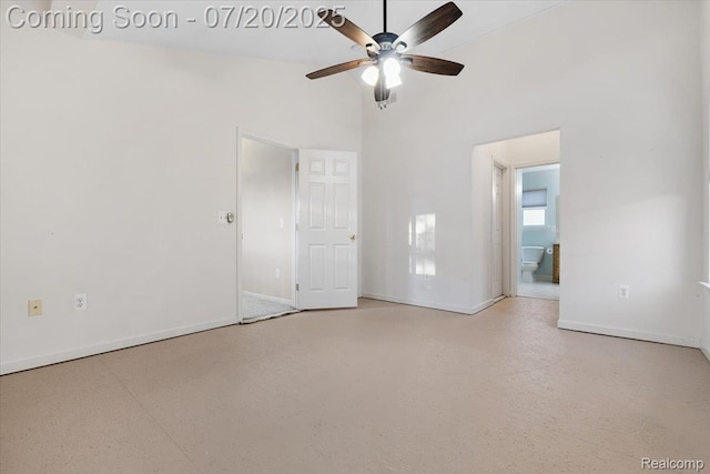 1145 York Ave, Howell, MI 48843 - unfurnished bedroom featuring concrete floors, high vaulted ceiling, ensuite bathroom, and a ceiling fan