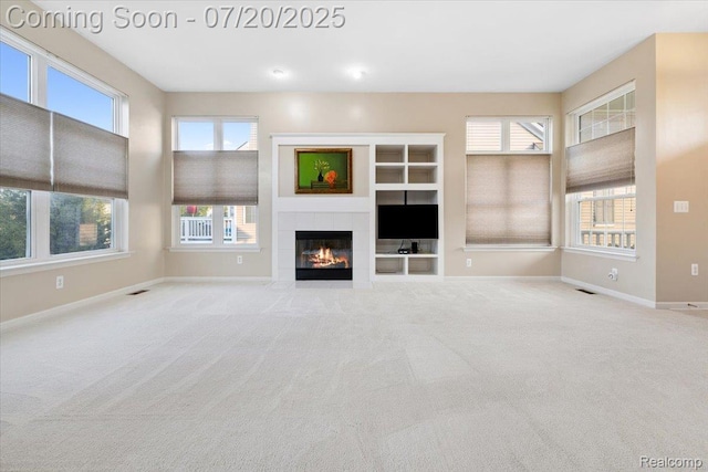 1145 York Ave, Howell, MI 48843 - unfurnished living room featuring a fireplace and carpet floors
