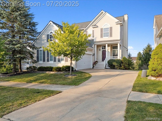 1145 York Ave, Howell, MI 48843 - view of front of property featuring driveway, a front yard, a chimney, and an attached garage