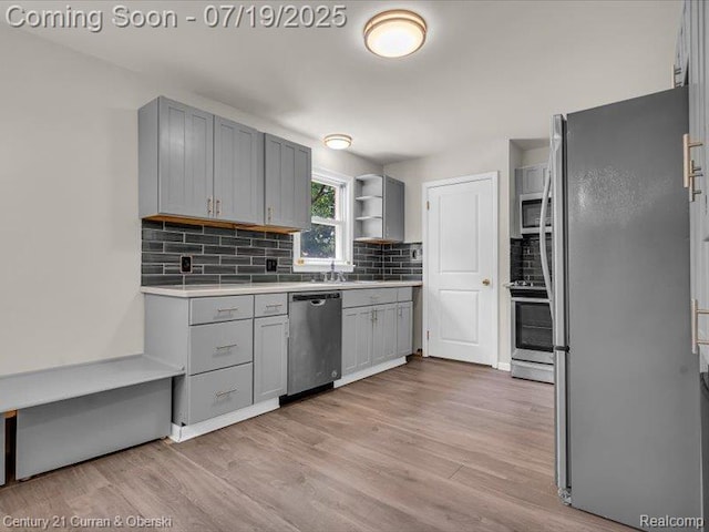 3850 Parker St, Dearborn, MI 48124 - kitchen with appliances with stainless steel finishes, gray cabinetry, and light wood-type flooring
