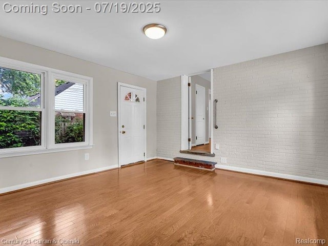 3850 Parker St, Dearborn, MI 48124 - entryway featuring brick wall and wood finished floors