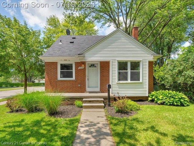 3850 Parker St, Dearborn, MI 48124 - bungalow featuring a chimney, a front lawn, roof with shingles, and brick siding