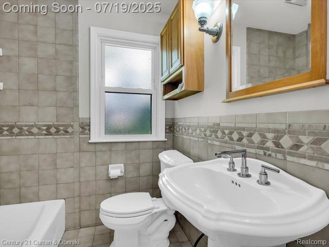 3850 Parker St, Dearborn, MI 48124 - full bath with tile walls, a bathtub, tile patterned flooring, and wainscoting