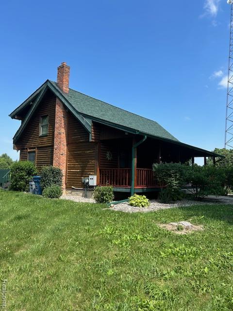 20100 Hickory Ridge Rd, Holly, MI 48442 - rear view of property with a chimney and a yard
