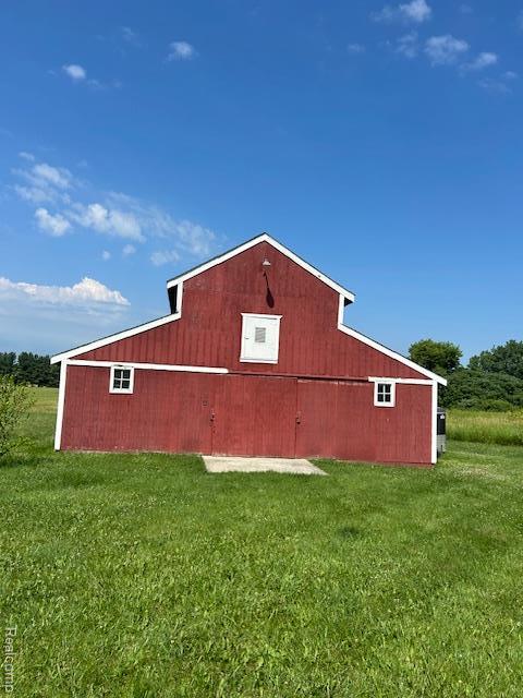 20100 Hickory Ridge Rd, Holly, MI 48442 - view of property exterior featuring a barn, a lawn, and an outdoor structure
