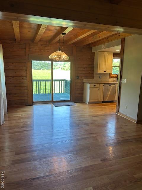 20100 Hickory Ridge Rd, Holly, MI 48442 - unfurnished living room with light wood-style floors, wooden walls, and a wood ceiling with exposed beams