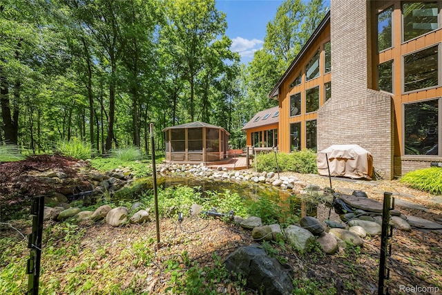 8931 Bridge Rd, Grosse Ile, MI 48138 - view of yard with a gazebo, a deck, and a small pond