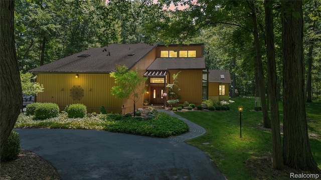 8931 Bridge Rd, Grosse Ile, MI 48138 - view of front facade featuring a front yard and roof with shingles
