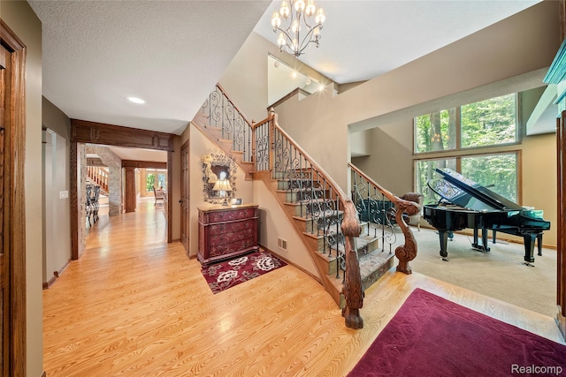 8931 Bridge Rd, Grosse Ile, MI 48138 - stairway with wood finished floors, recessed lighting, and ornate columns