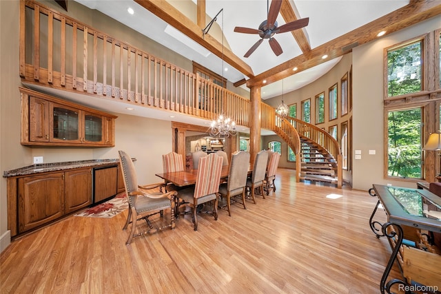 8931 Bridge Rd, Grosse Ile, MI 48138 - dining room with a towering ceiling, a chandelier, light wood-style flooring, stairway, and recessed lighting