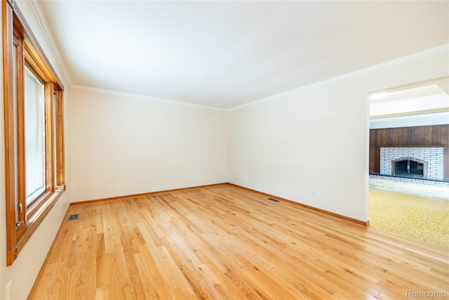 21819 Meridian Rd, Grosse Ile, MI 48138 - empty room featuring wood finished floors, a fireplace, and crown molding