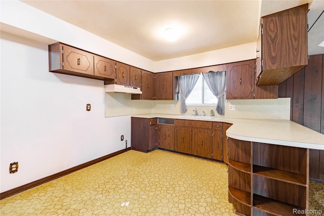 21819 Meridian Rd, Grosse Ile, MI 48138 - kitchen with under cabinet range hood, light countertops, and light floors