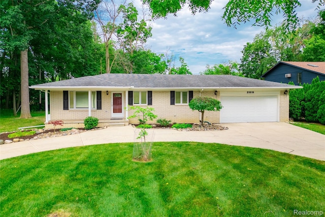 21819 Meridian Rd, Grosse Ile, MI 48138 - ranch-style home featuring brick siding, a garage, driveway, and a front lawn