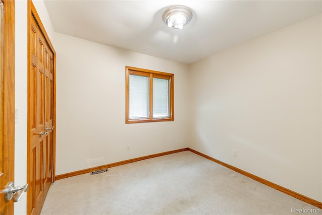 21819 Meridian Rd, Grosse Ile, MI 48138 - unfurnished bedroom featuring light carpet and a closet