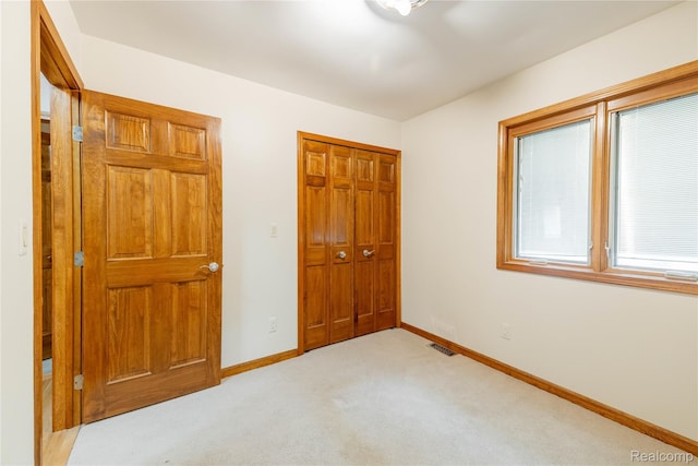 21819 Meridian Rd, Grosse Ile, MI 48138 - unfurnished bedroom with light carpet and a closet
