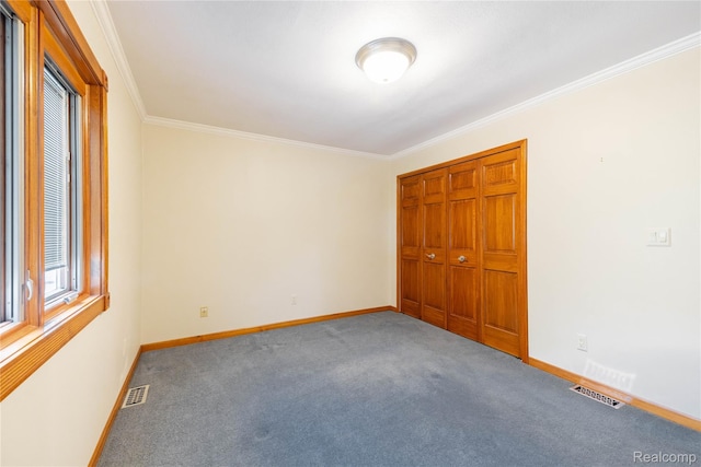 21819 Meridian Rd, Grosse Ile, MI 48138 - unfurnished bedroom with crown molding, carpet, and a closet