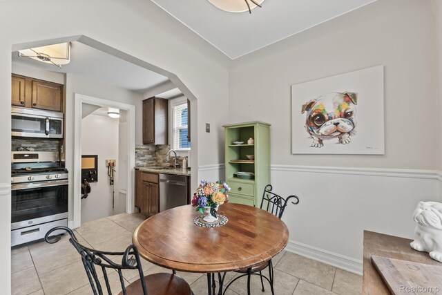 1405 Fielding St, Ferndale, MI 48220 - dining area with light tile patterned floors and arched walkways