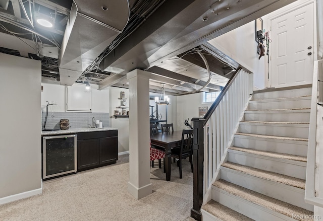1405 Fielding St, Ferndale, MI 48220 - basement featuring beverage cooler, light carpet, stairway, and bar