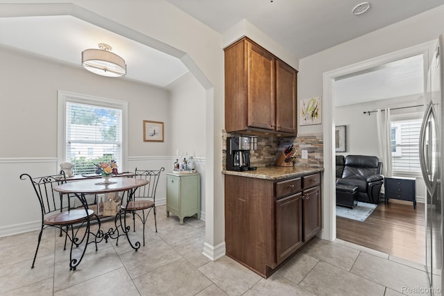 1405 Fielding St, Ferndale, MI 48220 - kitchen featuring plenty of natural light, decorative backsplash, freestanding refrigerator, and light tile patterned floors