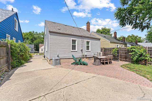 1405 Fielding St, Ferndale, MI 48220 - back of property with a patio area, roof with shingles, a fenced backyard, and a chimney