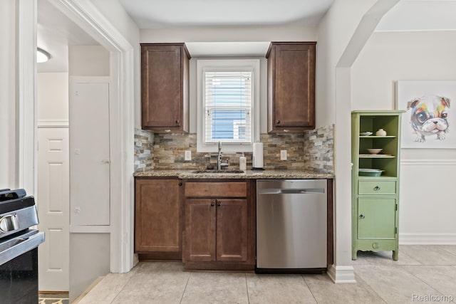 1405 Fielding St, Ferndale, MI 48220 - kitchen featuring stainless steel appliances, stone countertops, backsplash, and dark brown cabinetry