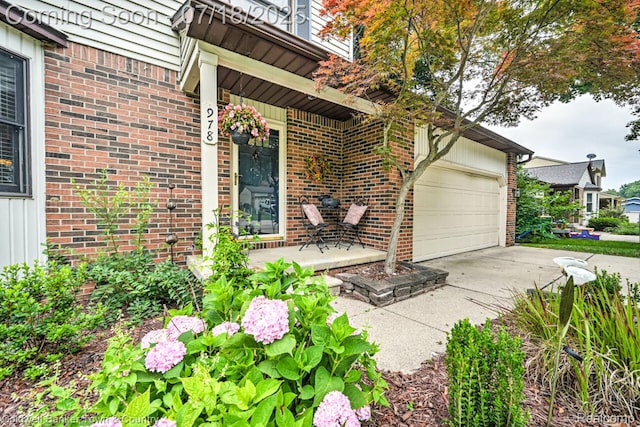 978 Oak Ridge Cir, Brighton, MI 48116 - entrance to property with driveway, brick siding, and a garage