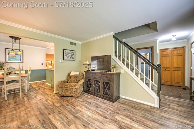 978 Oak Ridge Cir, Brighton, MI 48116 - living room featuring crown molding, wood finished floors, and stairs