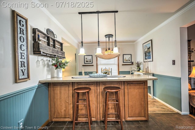 978 Oak Ridge Cir, Brighton, MI 48116 - bar with a wainscoted wall, ornamental molding, and pendant lighting