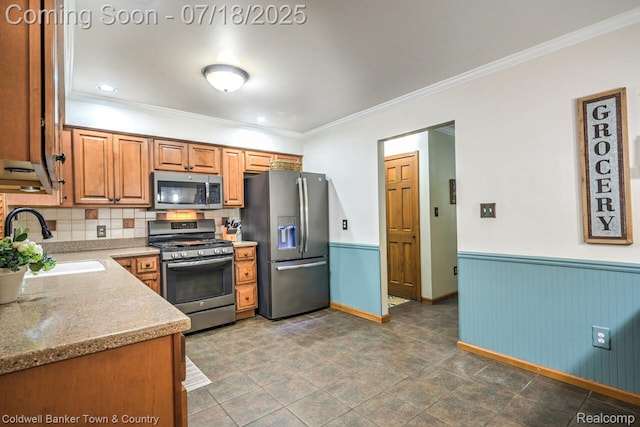 978 Oak Ridge Cir, Brighton, MI 48116 - kitchen featuring appliances with stainless steel finishes, ornamental molding, wainscoting, tasteful backsplash, and brown cabinetry