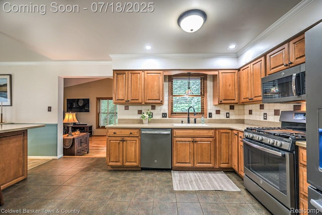978 Oak Ridge Cir, Brighton, MI 48116 - kitchen with stainless steel appliances, ornamental molding, healthy amount of natural light, light countertops, and brown cabinetry