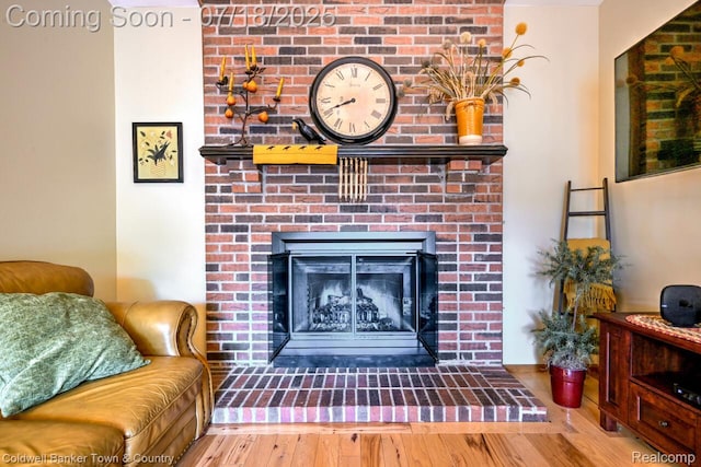 978 Oak Ridge Cir, Brighton, MI 48116 - detailed view of wood finished floors and a brick fireplace