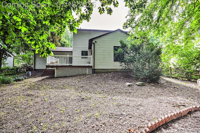 978 Oak Ridge Cir, Brighton, MI 48116 - back of property featuring a deck